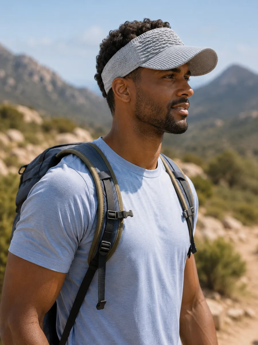 Dark-skinned man wearing gray visor